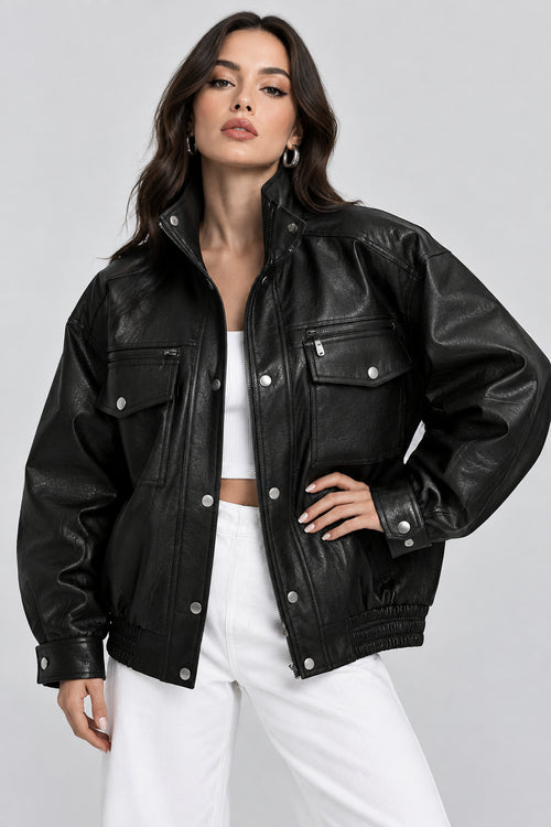 Woman wearing a black leather jacket on a plain background